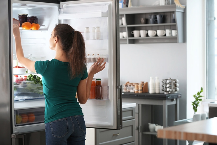 woman cleaning fridge