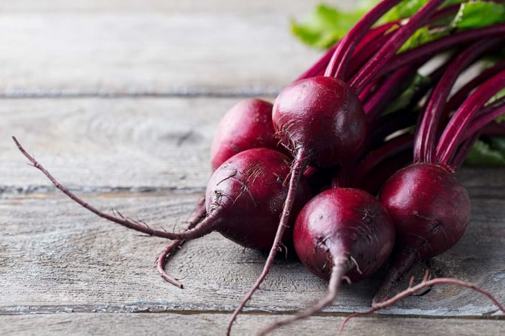 Fresh organic beet, beetroot. Grey rustic wooden background. Close up.