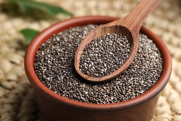 Bowl and spoon with chia seeds, closeup