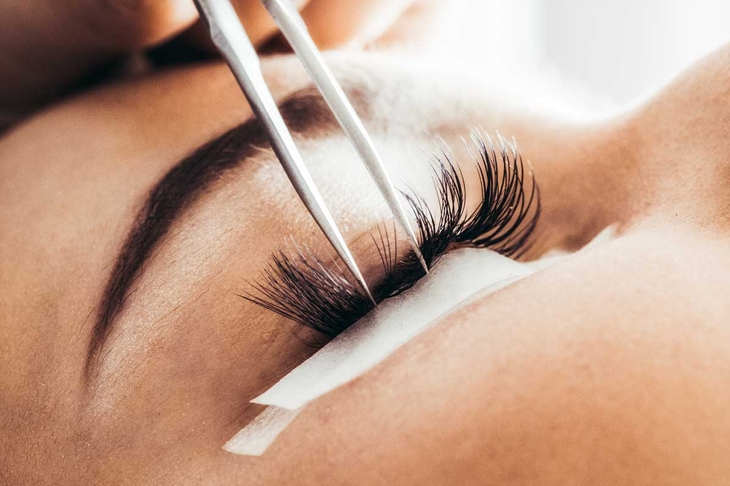 Beautician making artificial lashes. eyelash extension procedure